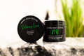 Relaxing Love whipped body butter in a Neeno Body black jar on a marble countertop, green plant in the back