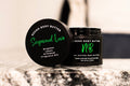 Sugawood body butter by Neeno,  in an elegant black jar with a matching black lid.