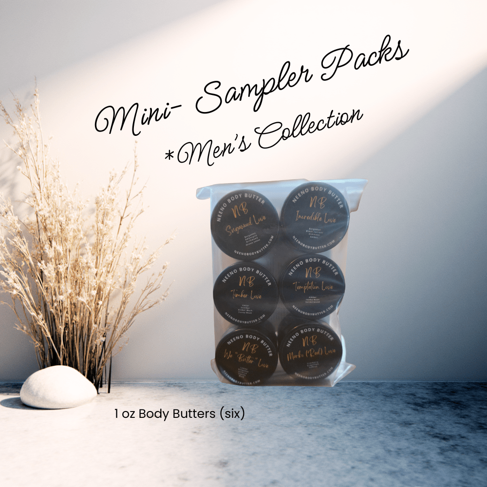 Six mini jars of Neeno Body Butter next to a white rock and tan decorative shrubs