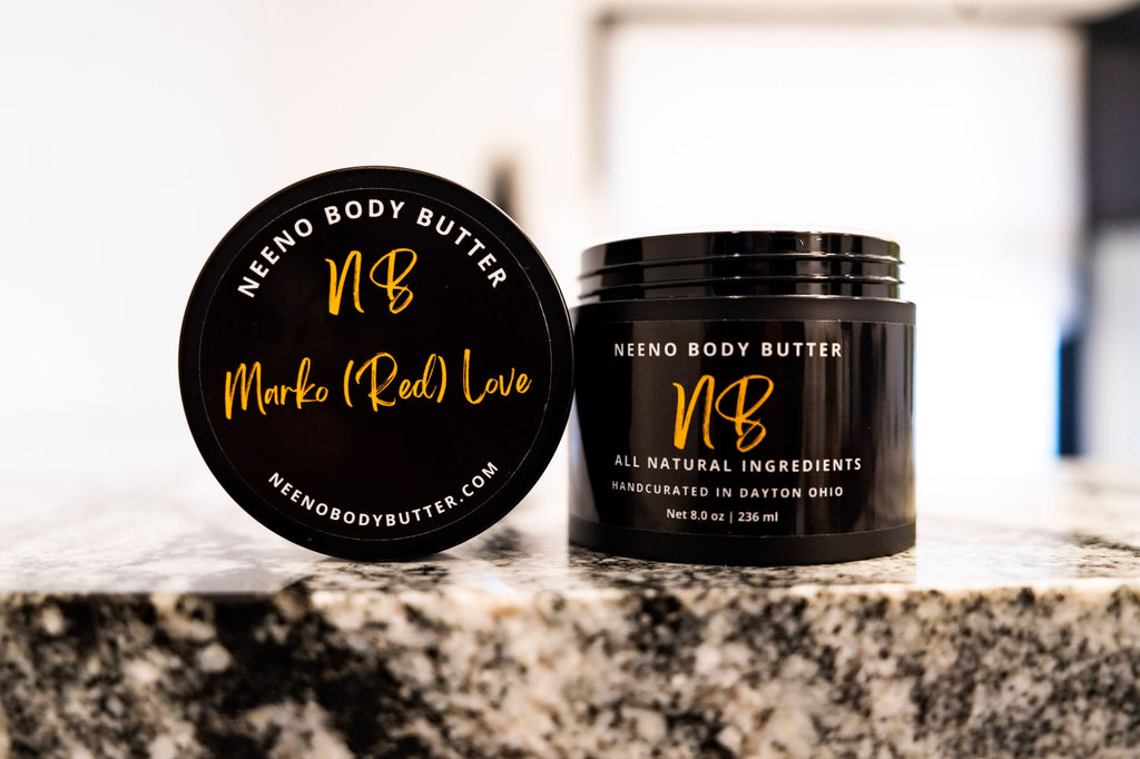 Marko Red Love whipped body butter in a Neeno Body black jar on a marble countertop