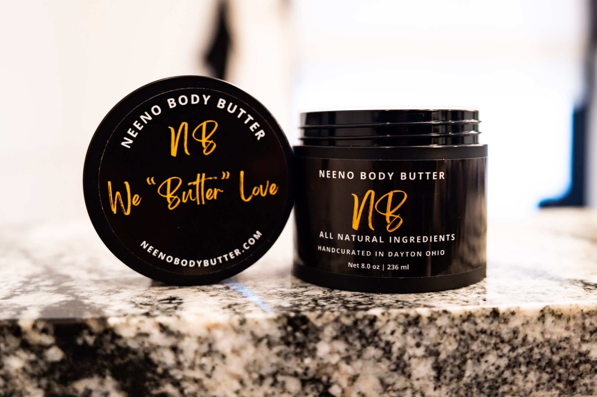 We "Butter" Love whipped body butter in a Neeno Body black jar on a marble countertop