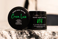 Crown Love body butter by Neeno,  in an elegant black jar with a matching black lid. The product name is displayed in white cursive font on the lid, with the tagline "All Natural Body Butter" 