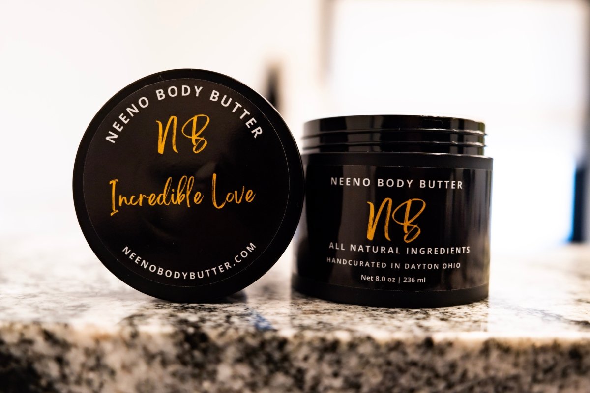 Incredible Love whipped cream body butter in a Neeno Body black jar on a marble countertop