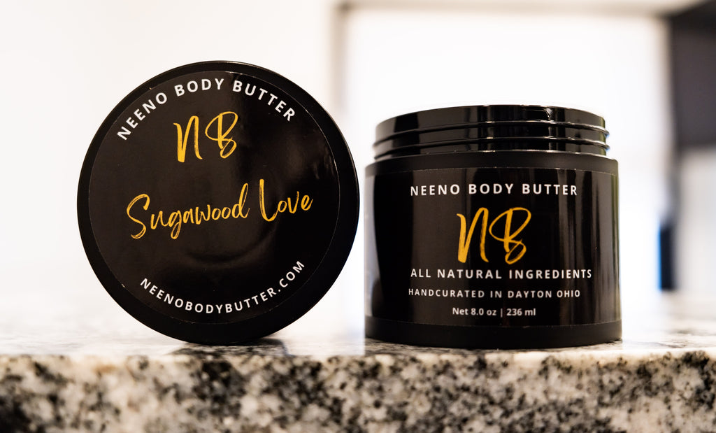 Sugawood Love whipped body butter in a Neeno Body black jar on a marble countertop