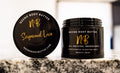 Sugawood Love whipped body butter in a Neeno Body black jar on a marble countertop