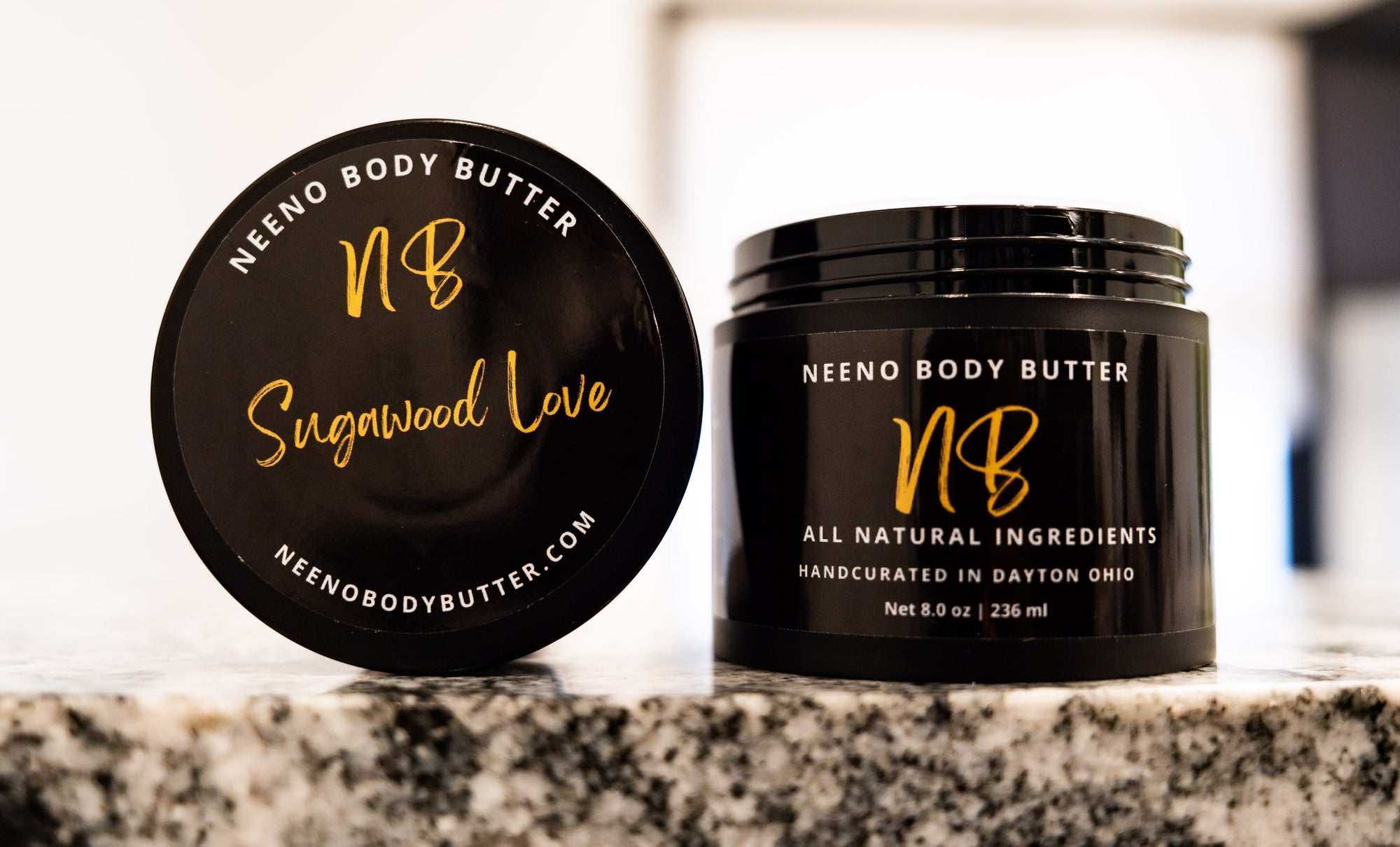 Sugawood Love whipped body butter in a Neeno Body black jar on a marble countertop