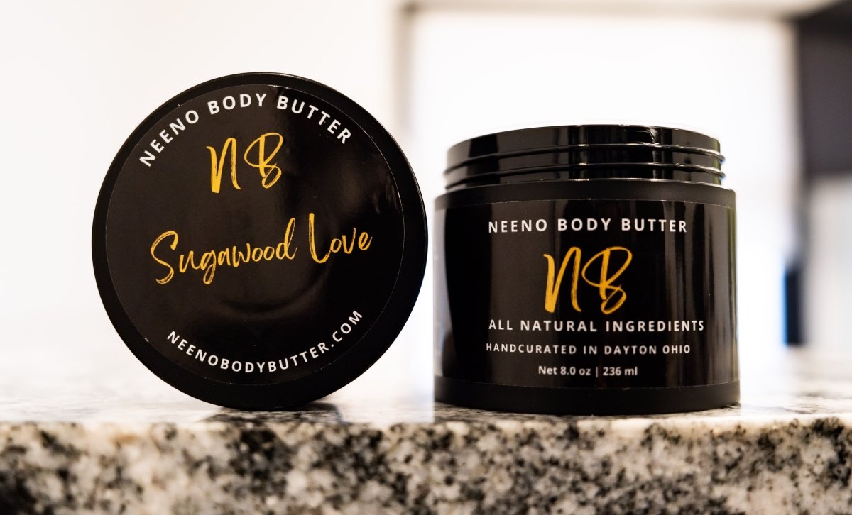 Sugawood Love whipped body butter in a Neeno Body black jar on a marble countertop