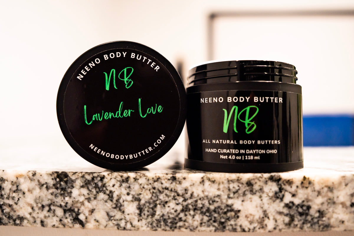 Lavender Love whipped body butter in a Neeno Body black jar on a marble countertop