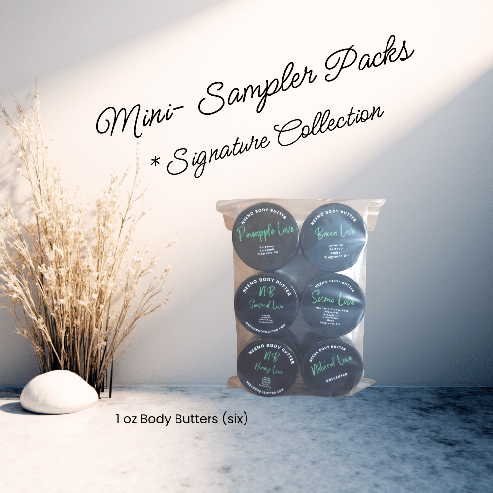 Six mini jars of Neeno Body Butter next to a white rock and tan decorative shrubs