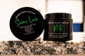 Sumo Love creamy whipped body butter in a Neeno Body branded black jar on a marble countertop
