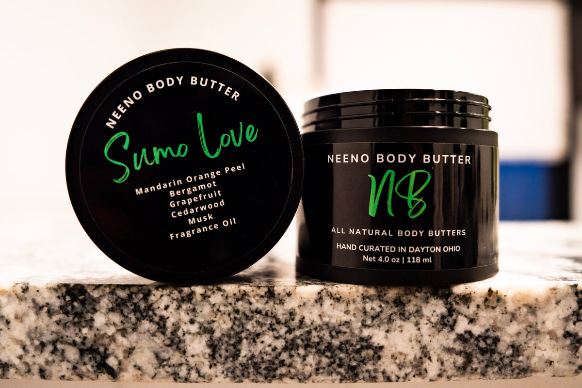 Sumo Love whipped body butter in a Neeno Body branded black jar on a marble countertop