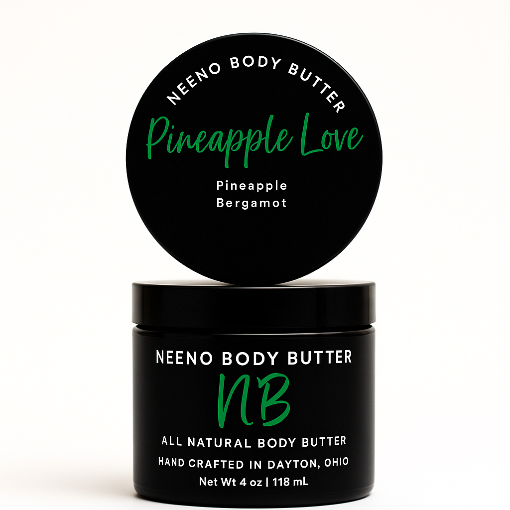 Pineapple Love whipped body butter in a Neeno Body black jar on a marble countertop