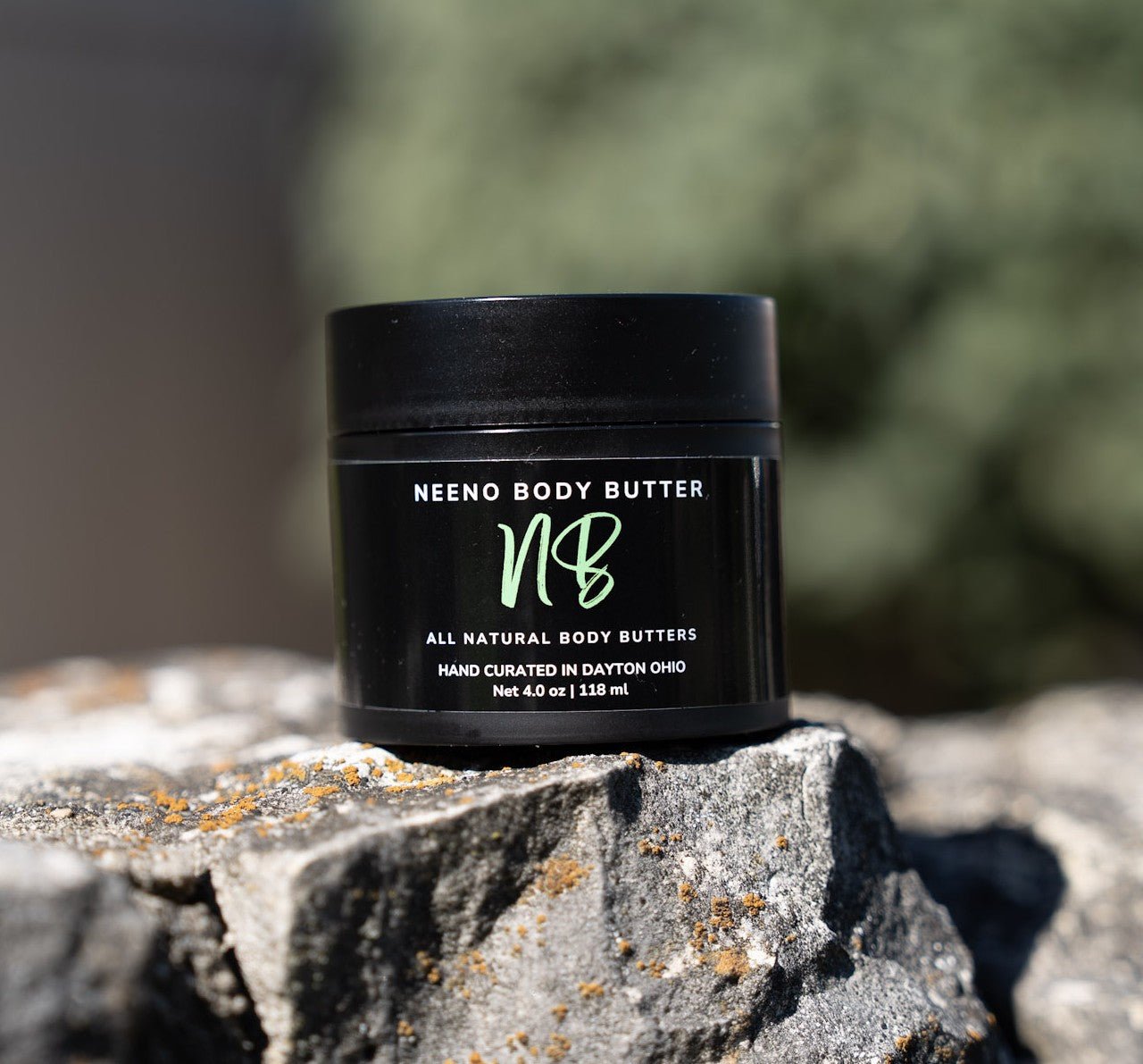 Sumo Love creamy whipped body butter in a Neeno Body branded black jar on a marble countertop