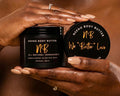 Two hands holding a Neeno Body Butter container with visible branding.